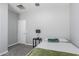 Bedroom with carpet flooring, door, bedside table and lamp at 40027 W Pryor Ln, Maricopa, AZ 85138