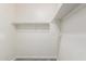 Walk in closet with neutral carpet and white shelving at 40027 W Pryor Ln, Maricopa, AZ 85138
