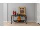 Elegant entryway table adorned with decorative vases, candlesticks and artwork adds character to the home at 40027 W Pryor Ln, Maricopa, AZ 85138