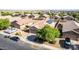 Aerial view of home's exterior featuring two-car garage and desert landscaping at 40027 W Pryor Ln, Maricopa, AZ 85138