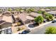 Aerial view of the home's exterior with a two car garage, desert landscaping, and fencing at 40027 W Pryor Ln, Maricopa, AZ 85138