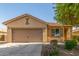 Inviting single-story house with a two-car garage, complemented by desert-style landscaping and a tiled roof at 40027 W Pryor Ln, Maricopa, AZ 85138