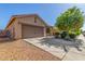 Attractive home with a large driveway, two-car garage, and desert landscaping for easy maintenance at 40027 W Pryor Ln, Maricopa, AZ 85138