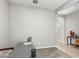 Neutral home office features a modern gray desk and a door to the entryway at 40027 W Pryor Ln, Maricopa, AZ 85138
