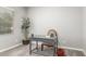 Home office features a desk, chair, and decorative plant near the window for a calm work environment at 40027 W Pryor Ln, Maricopa, AZ 85138