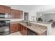 Well-equipped kitchen with granite countertops, stainless steel sink, and modern appliances at 40027 W Pryor Ln, Maricopa, AZ 85138