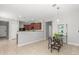 Modern kitchen with wooden cabinets, updated appliances, and a breakfast bar at 40027 W Pryor Ln, Maricopa, AZ 85138