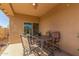 Covered patio featuring a table and chairs, perfect for outdoor dining and relaxing at 40027 W Pryor Ln, Maricopa, AZ 85138
