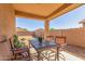 Covered patio featuring a table and chairs, perfect for outdoor dining and relaxing at 40027 W Pryor Ln, Maricopa, AZ 85138
