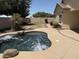 Private backyard oasis featuring a sparkling pool with a rock feature, lush lawn, and mature landscaping at 4523 E Gleneagle Dr, Chandler, AZ 85249
