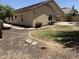 Landscaped backyard featuring a covered patio, lush greenery, and a paver path leading to a separate seating area at 4523 E Gleneagle Dr, Chandler, AZ 85249