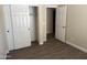 Bedroom with wood-look laminate flooring, neutral paint, and a closet with sliding doors at 4523 E Gleneagle Dr, Chandler, AZ 85249