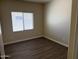 Cozy bedroom with neutral paint, laminate flooring, and a window offering ample natural light at 4523 E Gleneagle Dr, Chandler, AZ 85249