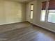 Spacious living room with new laminate wood flooring and ample natural light from the large windows at 4523 E Gleneagle Dr, Chandler, AZ 85249