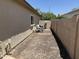 Narrow side yard featuring gravel, a block fence, and pool equipment at 4523 E Gleneagle Dr, Chandler, AZ 85249
