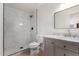 Modern bathroom featuring a walk-in shower with marble tiling, gray vanity, and gold accents at 527 N Pasadena --, Mesa, AZ 85201