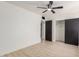 Bright bedroom featuring light wood floors, ceiling fan, closet, and neutral walls at 527 N Pasadena --, Mesa, AZ 85201
