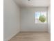 Bright bedroom showcasing wood-look flooring and view of the trees outside at 527 N Pasadena --, Mesa, AZ 85201