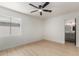 Sunlit bedroom featuring modern ceiling fan and convenient ensuite bathroom access at 527 N Pasadena --, Mesa, AZ 85201