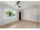 Light filled bedroom boasts a modern ceiling fan and wood-look vinyl floors at 527 N Pasadena --, Mesa, AZ 85201