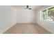 Light filled bedroom boasts a modern ceiling fan and wood-look vinyl floors at 527 N Pasadena --, Mesa, AZ 85201