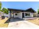 Charming single story home with covered parking, white exterior and low brick wall surrounding the property at 527 N Pasadena --, Mesa, AZ 85201