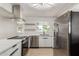 Modern kitchen features stainless steel appliances, white cabinets, quartz countertops and ample natural light at 527 N Pasadena --, Mesa, AZ 85201