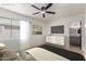 Staged bedroom features a large window, TV, and ensuite bathroom at 527 N Pasadena --, Mesa, AZ 85201