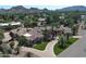 An expansive home displays lush landscaping, a circular driveway, and a picturesque mountain backdrop at 6305 E Arabian Way, Paradise Valley, AZ 85253