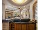 Wet bar has custom cabinets and tile accents, seamlessly integrating with the open living space at 6305 E Arabian Way, Paradise Valley, AZ 85253