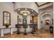 Wet bar has tile accents, seating, and custom cabinetry for entertaining guests at 6305 E Arabian Way, Paradise Valley, AZ 85253