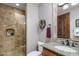 Tiled bathroom featuring a glass shower, granite countertop, and modern fixtures at 6305 E Arabian Way, Paradise Valley, AZ 85253