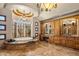 A bathroom with a soaking tub, a vanity with storage, and decorative lighting at 6305 E Arabian Way, Paradise Valley, AZ 85253