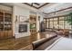 Primary bedroom featuring hardwood floors, a fireplace, built-in bookshelves, and bright windows at 6305 E Arabian Way, Paradise Valley, AZ 85253