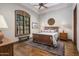 Comfortable bedroom with hardwood floors, shuttered window, and stylish furnishings at 6305 E Arabian Way, Paradise Valley, AZ 85253