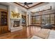 A bedroom with hardwood floors, a fireplace, large windows, and wooden trim at 6305 E Arabian Way, Paradise Valley, AZ 85253