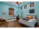 A bright bedroom painted blue featuring wood floors, a tray ceiling, and a window seat at 6305 E Arabian Way, Paradise Valley, AZ 85253