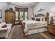 Bedroom with a large bed, shuttered windows, and a cozy seating area at 6305 E Arabian Way, Paradise Valley, AZ 85253
