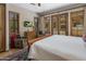 Bright bedroom with outdoor access, sitting area, and large windows with views of the lush outdoor scenery at 6305 E Arabian Way, Paradise Valley, AZ 85253