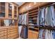 Spacious walk-in closet with custom wood shelving and drawers for organized storage at 6305 E Arabian Way, Paradise Valley, AZ 85253