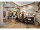 A dining room with an ornate chandelier, hardwood floors, and a bar area with seating at 6305 E Arabian Way, Paradise Valley, AZ 85253