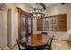 Charming dining room with a wood table, shuttered windows and a chandelier at 6305 E Arabian Way, Paradise Valley, AZ 85253