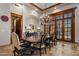 A dining room with a chandelier over a large wooden table and seating for ten people at 6305 E Arabian Way, Paradise Valley, AZ 85253