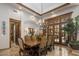Elegant dining room with a wood table, chandelier, and French doors for a luxurious dining experience at 6305 E Arabian Way, Paradise Valley, AZ 85253