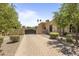 Private gated entrance with paver walkway and manicured shrubs at 6305 E Arabian Way, Paradise Valley, AZ 85253