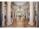 Grand entryway with stone columns, a decorative tiled floor, and a view of the billiards room at 6305 E Arabian Way, Paradise Valley, AZ 85253