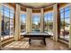 Game room has panoramic windows with views of pool, while offering ample natural light at 6305 E Arabian Way, Paradise Valley, AZ 85253