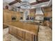 Gourmet kitchen featuring custom wood cabinets, granite countertops, a large center island and designer lighting at 6305 E Arabian Way, Paradise Valley, AZ 85253