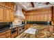 Gourmet kitchen features custom wood cabinets, granite countertops, and stainless steel appliances at 6305 E Arabian Way, Paradise Valley, AZ 85253