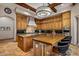 Gourmet kitchen features custom wood cabinets, granite countertops, island, and stainless steel appliances at 6305 E Arabian Way, Paradise Valley, AZ 85253